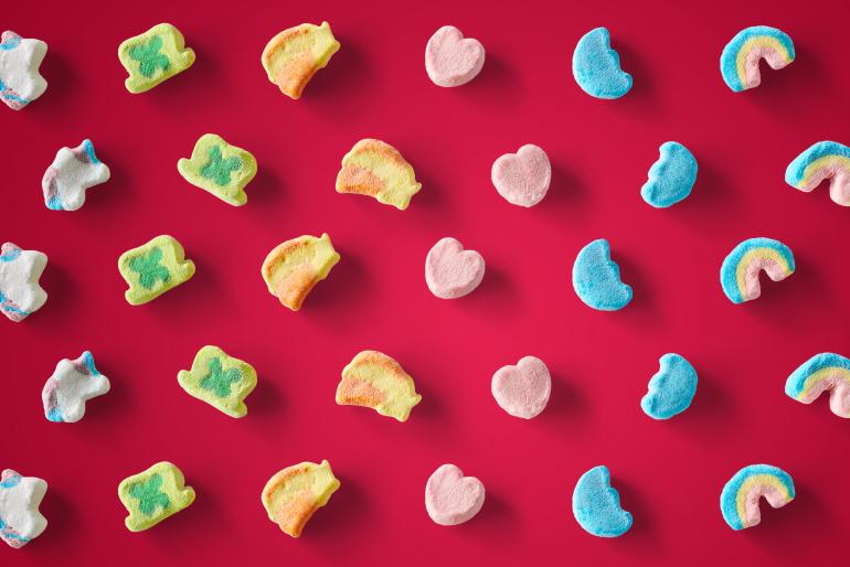 Lucky Charms marshmallow pieces on a red background