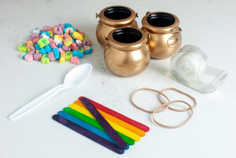 Homemade catapult supplies laid on table.