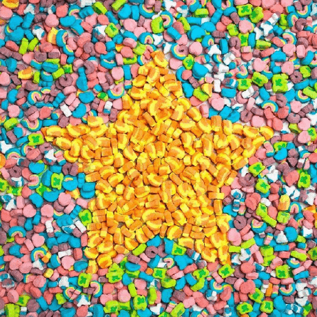 A pile of Lucky Charms™ with a golden star made of the cereal in the middle.